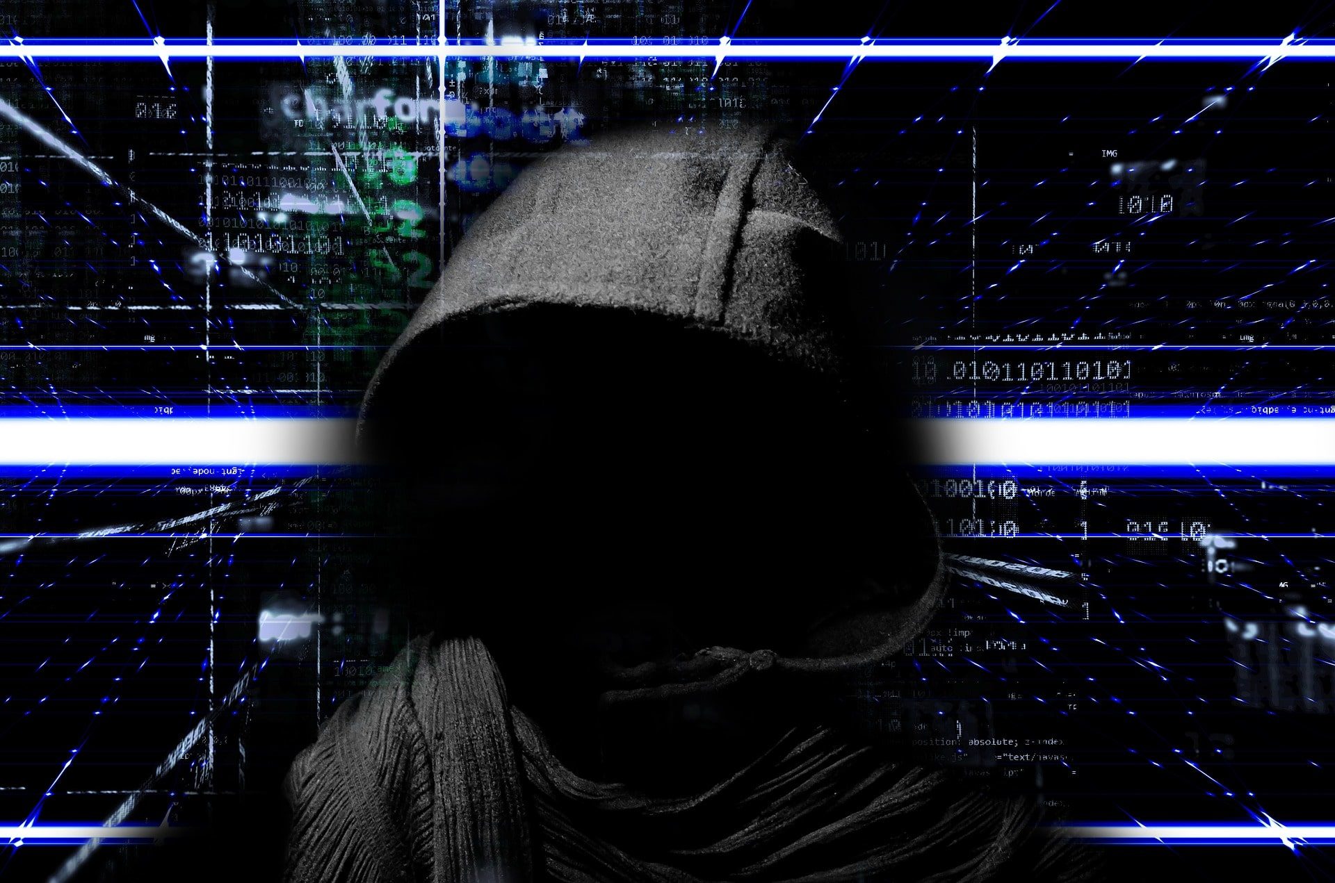 A depiction of cybercriminal in a black hoodie with a tech-related backdrop.