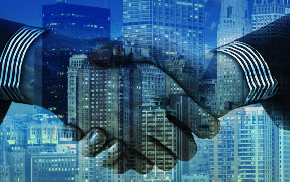 Ricardian smart contracts: An image of a handshake overlayed with a blue city background.