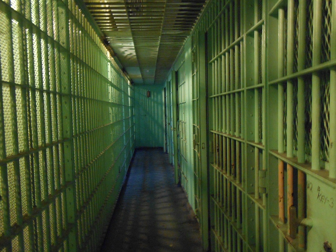 Blockchain fraud: An image showing a dark hallway of jail cells