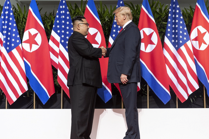 North Korea’s Crypto Operations Exposed: $1.65B Funneled to WMDs U.S. President Donald Trump and North Korea's Kim Jong Un shake hands during summit.