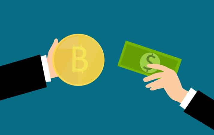 How to buy bitcoin with cash: a cartoon image of two hands, one holding a bitcoin, the other a dollar bill.